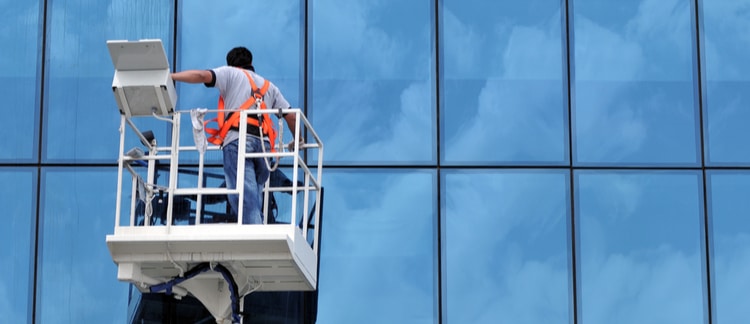 Window cleaner using bucket truck